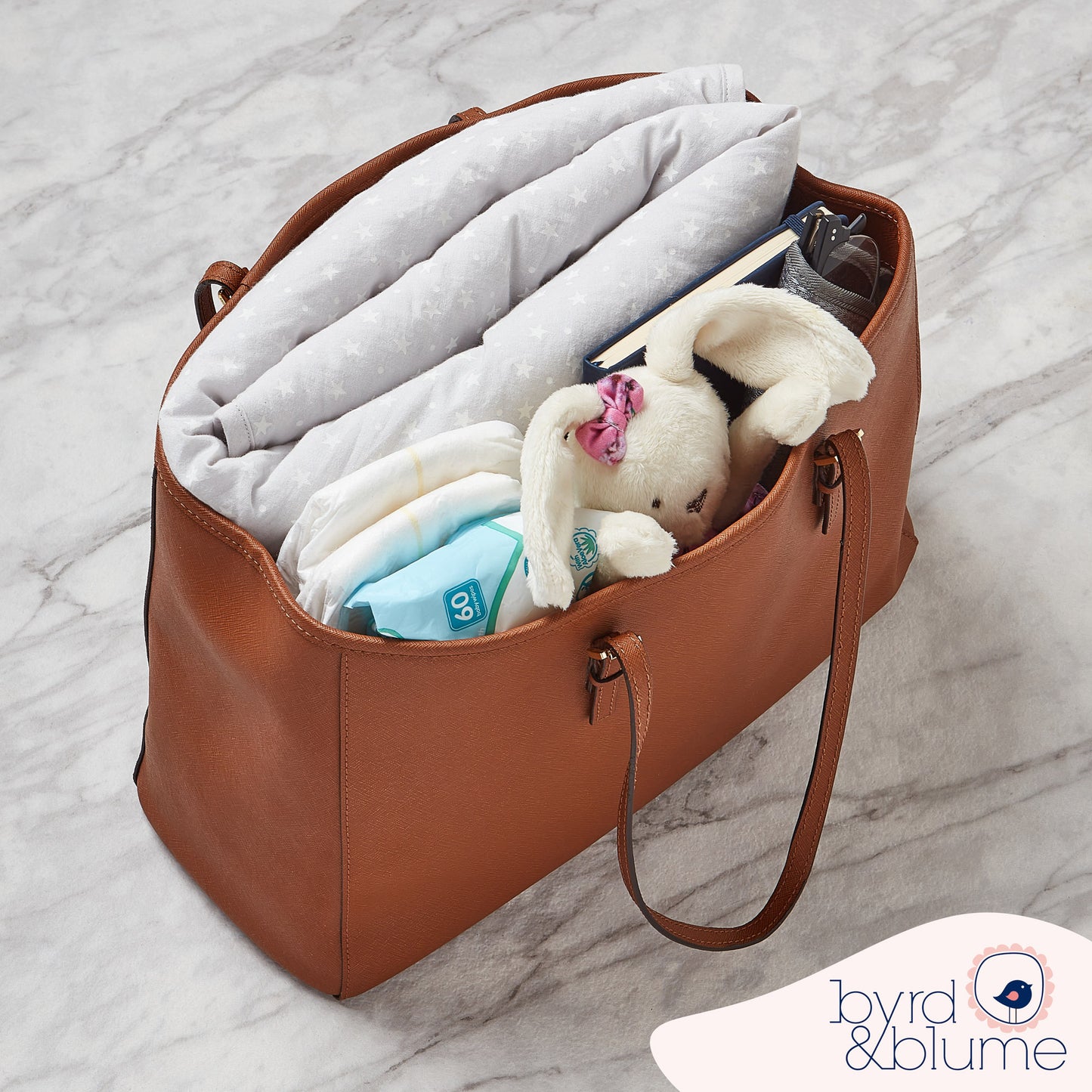 Foldable organic cotton playmat with soft padding, reversible design, ideal for travel and compact storage.